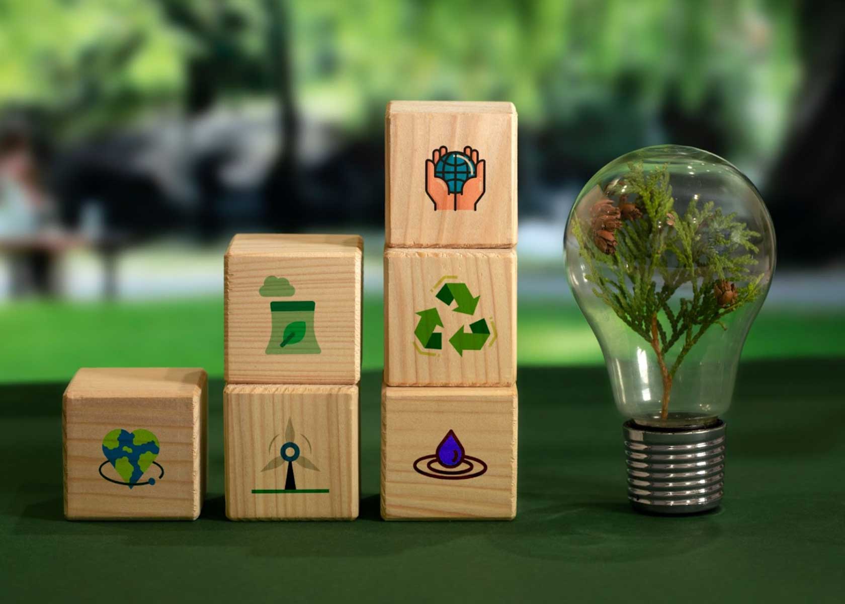 An image showing different building blocks stacked on top of each other, each block has an image that depicts green or low carbon future.